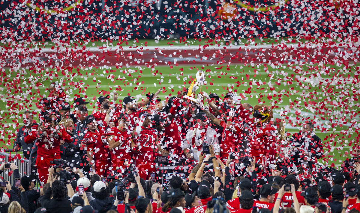 Confetti rains down as the championship trophy is celebrated by the Utah Utes with head coach M ...