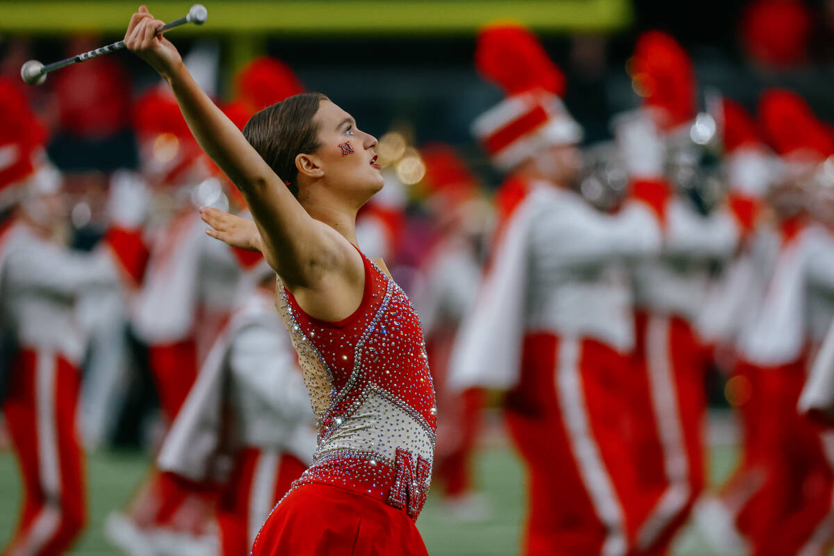 Nebraska baton twirler Britney Berry performs with the marching band before the Vegas Bowl on W ...