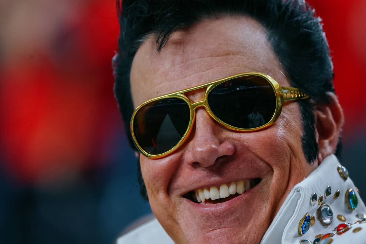 An Elvis Presley impersonator walks onto the field during the first half of the Vegas Bowl on W ...