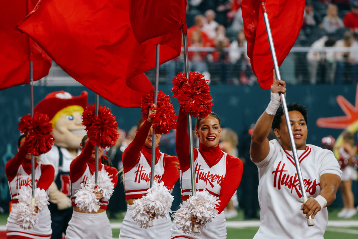 Nebraska cheerleaders run out with flags after a Nebraska touchdown during the second half of t ...