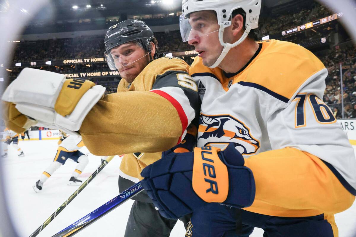 Golden Knights defenseman Jeremy Lauzon (5) hits Nashville Predators defenseman Brady Skjei (76 ...