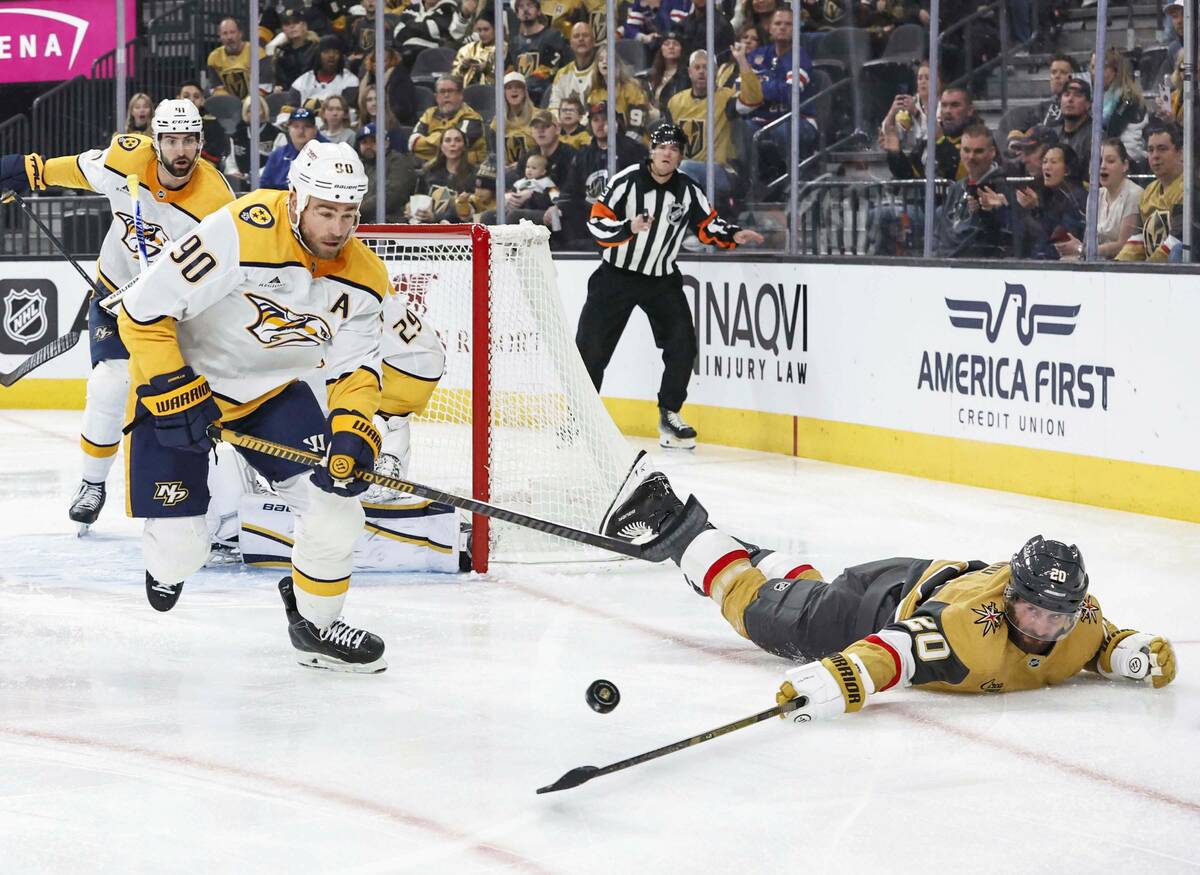 Golden Knights left wing Brandon Saad (20) extends for a puck with Nashville Predators center R ...