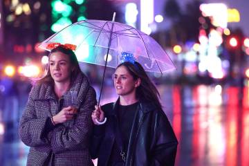 Rachel Whittet, left, and Steph Wager, right, both from Australia, walk along Las Vegas Bouleva ...
