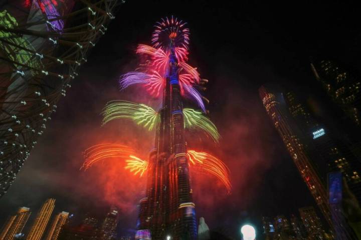 Fireworks explode around the Burj Khalifa, the world's tallest building, during New Year's Eve ...