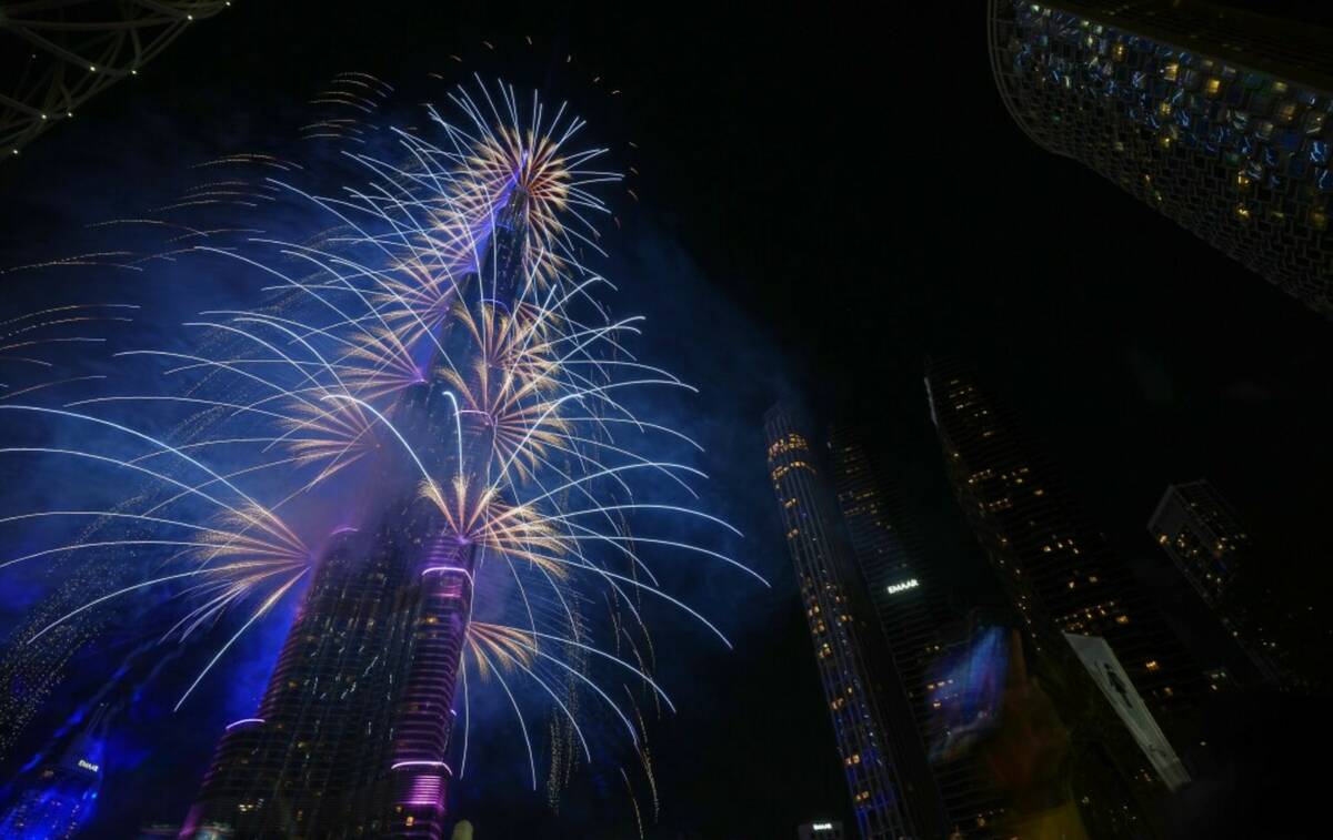 Fireworks explode around the Burj Khalifa, the world's tallest building, during New Year's Eve ...