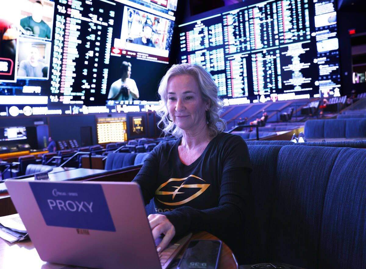 Toni Law, one of owners of Football Contest Proxy, works on her laptop as she waits to meet wit ...