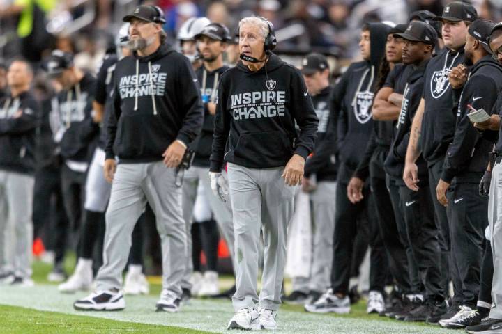 Raiders head coach Pete Carroll walks the sideline during the first half of an NFL game at Alle ...