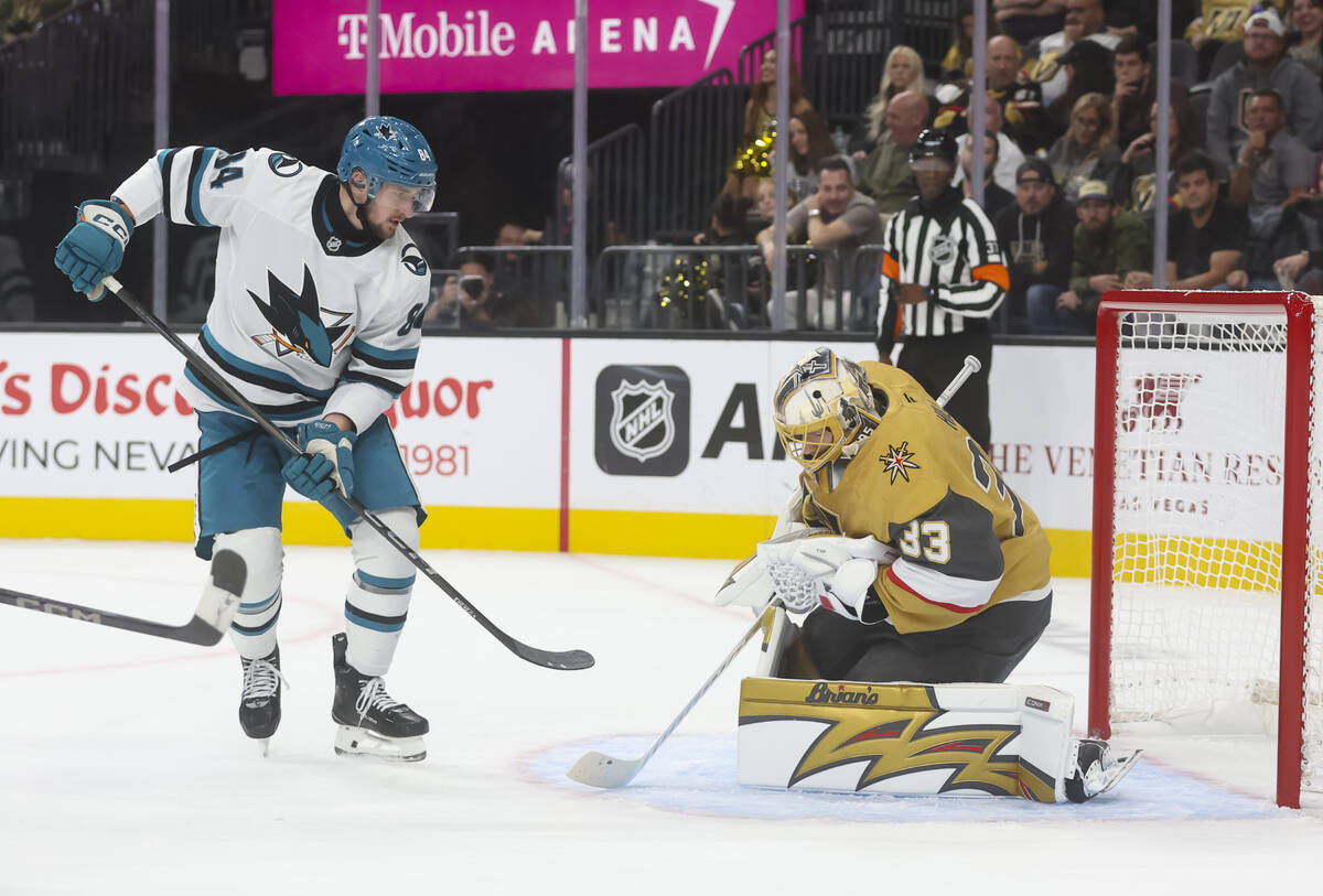 Golden Knights goaltender Adin Hill (33) stops the puck in front of San Jose Sharks left wing P ...