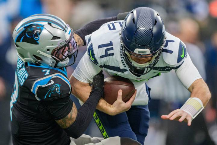 Carolina Panthers safety Tre'Von Moehrig (7) sacks Seattle Seahawks quarterback Sam Darnol ...