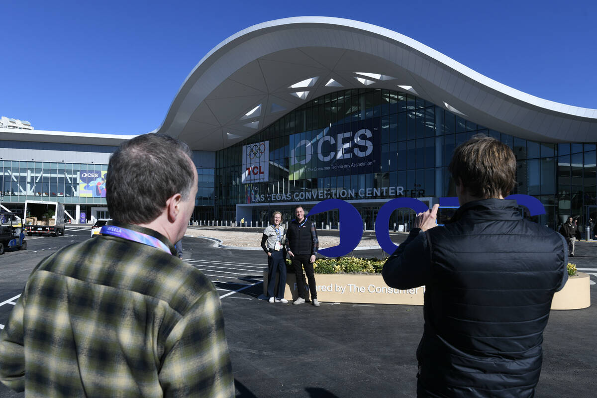 CES exhibitors take photos in front of the renovated Las Vegas Convention Center Monday, Januar ...