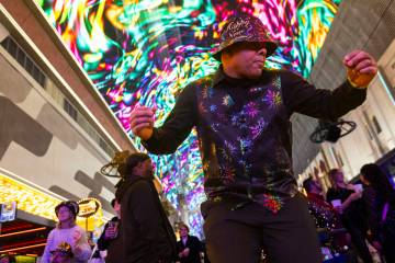 Ken Wigginton, of Rhode Island, dances as New Year's revelers gather at the Fremont Street ...