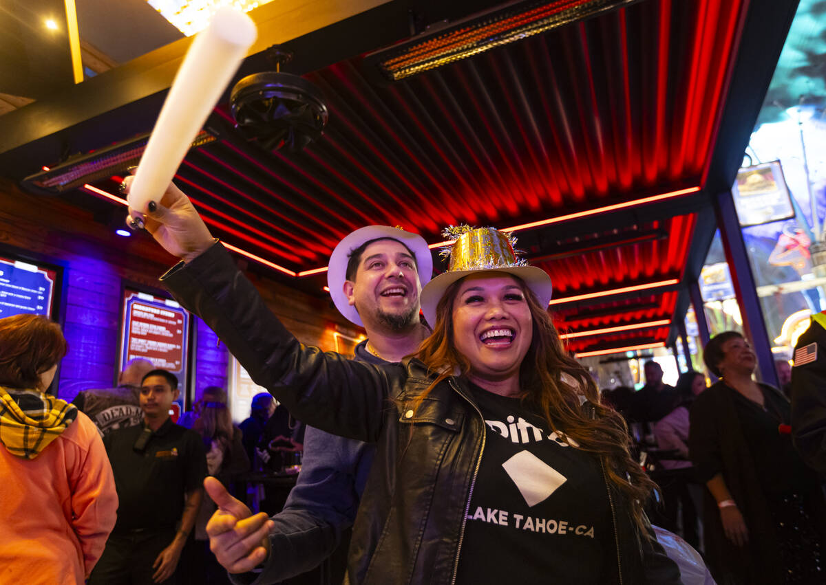 David, left, and Juliette, of Stockton, Calif., dance to a DJ as New Year's revelers gathe ...