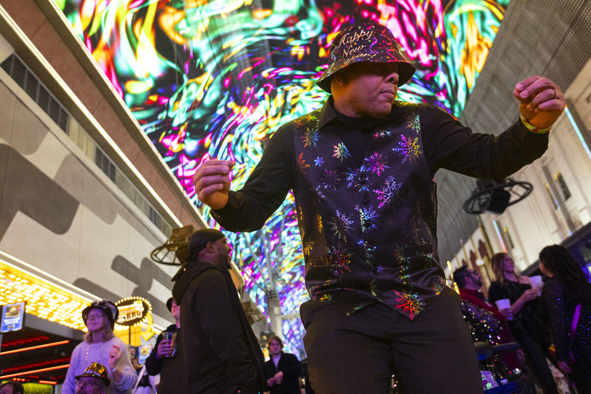 Ken Wigginton, of Rhode Island, dances as New Year's revelers gather at the Fremont Street ...