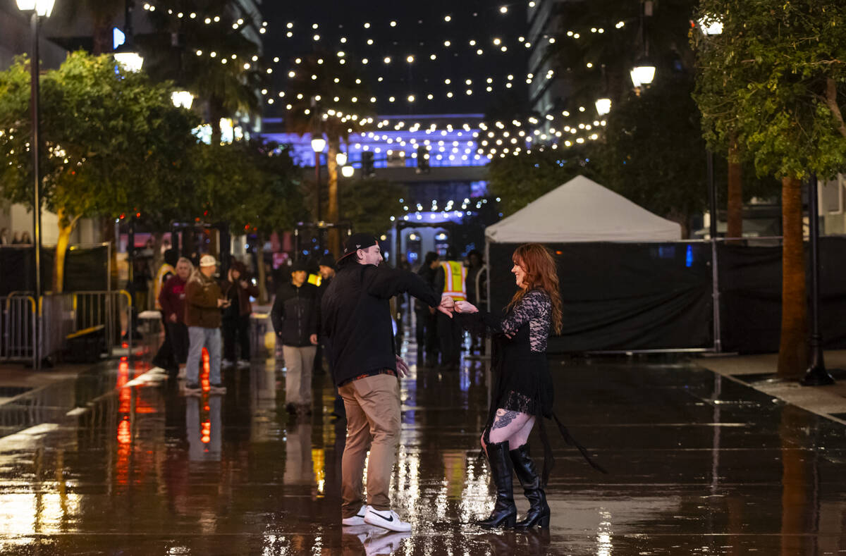 A couple dances as New Year's revelers gather at the Fremont Street Experience on Wednesda ...