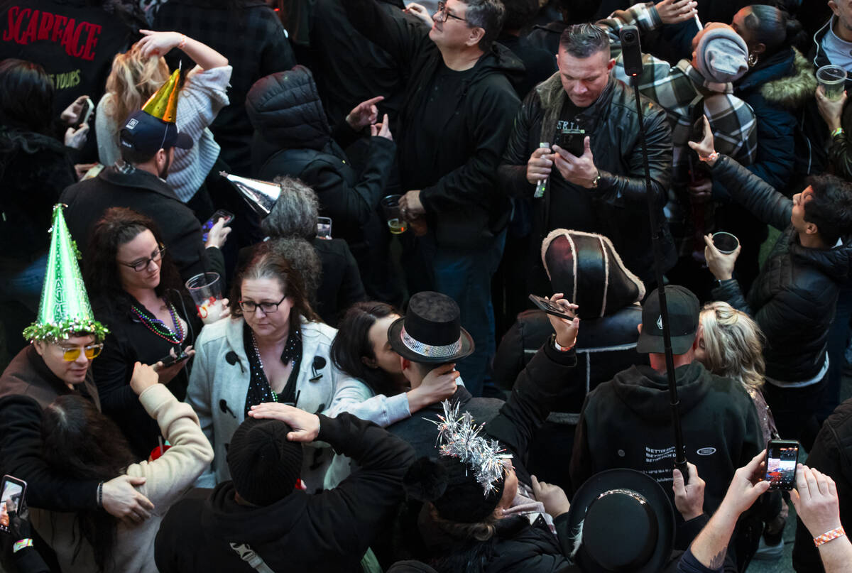 A couple kisses as revelers celebrate the new year at the Fremont Street Experience on Thursday ...
