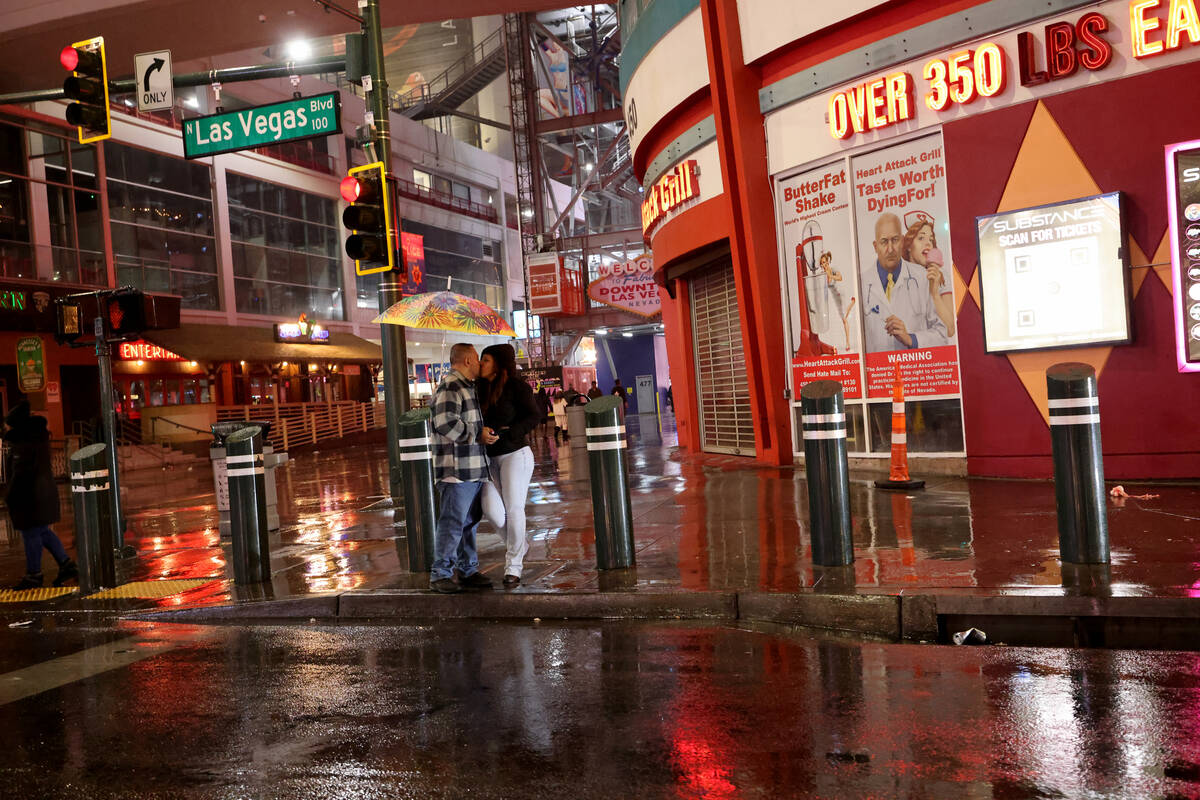 Beto and Jasmine, who declined to give their last names, of Chino, Calif., kiss at Las Vegas Bo ...