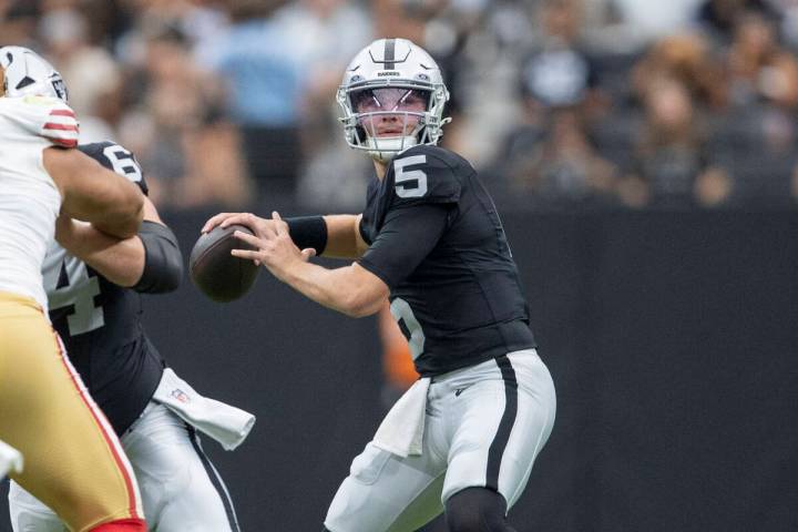 Raiders quarterback Cam Miller (5) drops back to throw against the San Francisco 49ers during t ...