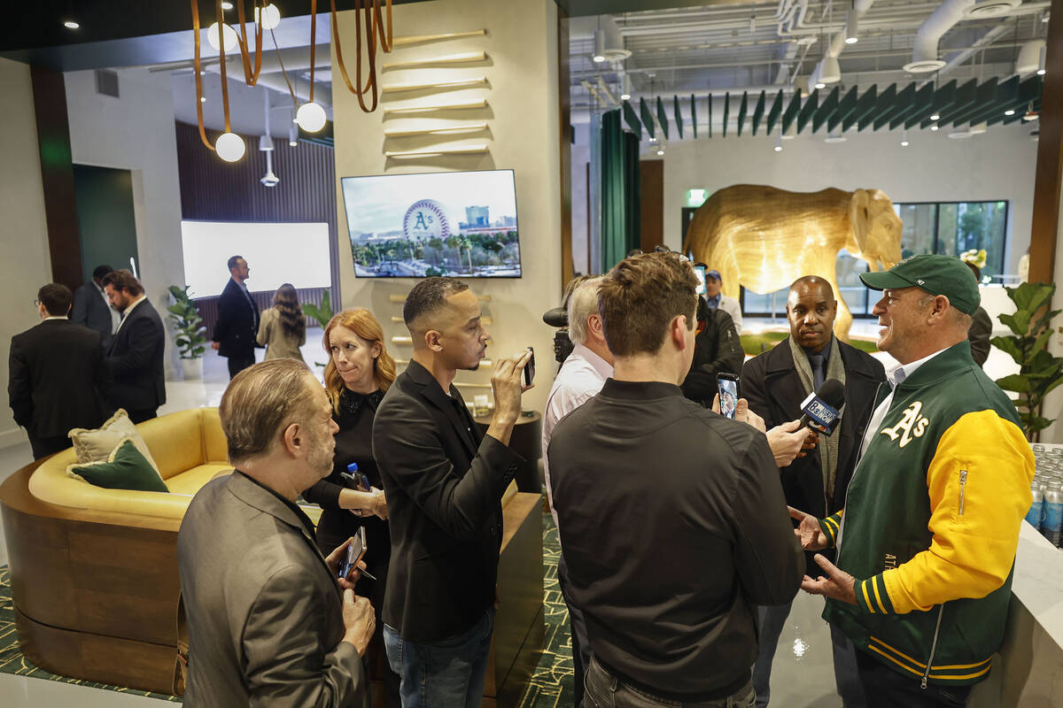 Athletics owner John Fisher, right, answers questions during a media tour of the team’s ...