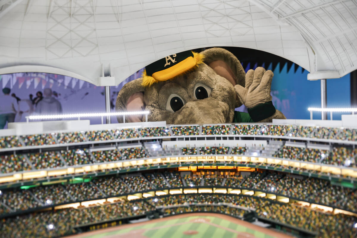 Mascot “Stomper” waves through a model of the future Athletics ballpark during a ...