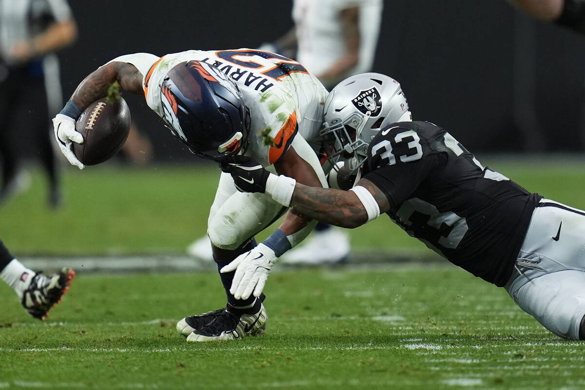 Las Vegas Raiders linebacker Jamal Adams (33) is called for a penalty while grabbing the face m ...