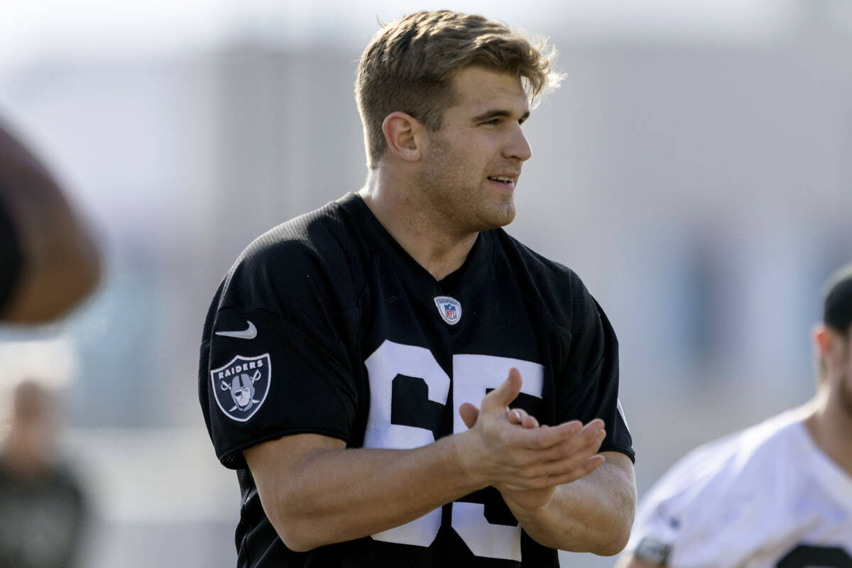 Raiders tight end Michael Mayer, wearing Alex Cappa’s jersey, claps during the team  ...