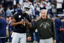 Raiders head coach Pete Carroll chats with Raiders quarterback Geno Smith (7) prior to an NFL f ...