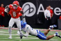 Air Force Falcons defensive back Korey Johnson (2) attempts to trip UNLV running back Jai' ...