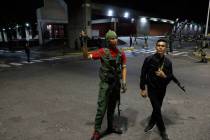 Members of the presidential guard stand outside the Miraflores presidential palace after explos ...