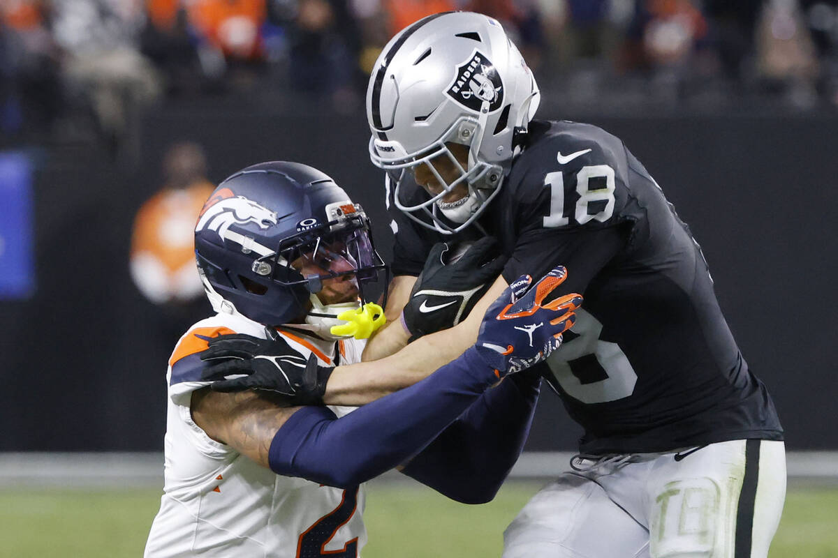 Raiders wide receiver Jack Bech (18) breaks a tackle from Denver Broncos cornerback Pat Surtain ...
