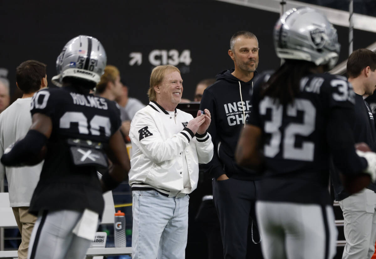 Raiders owner Mark Davis and General Manager John Spytek watch the team's warm-up before a ...