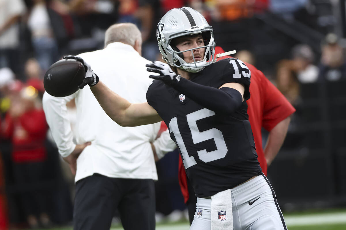 Raiders quarterback Kenny Pickett warms up before the start of an NFL game against the Kansas C ...