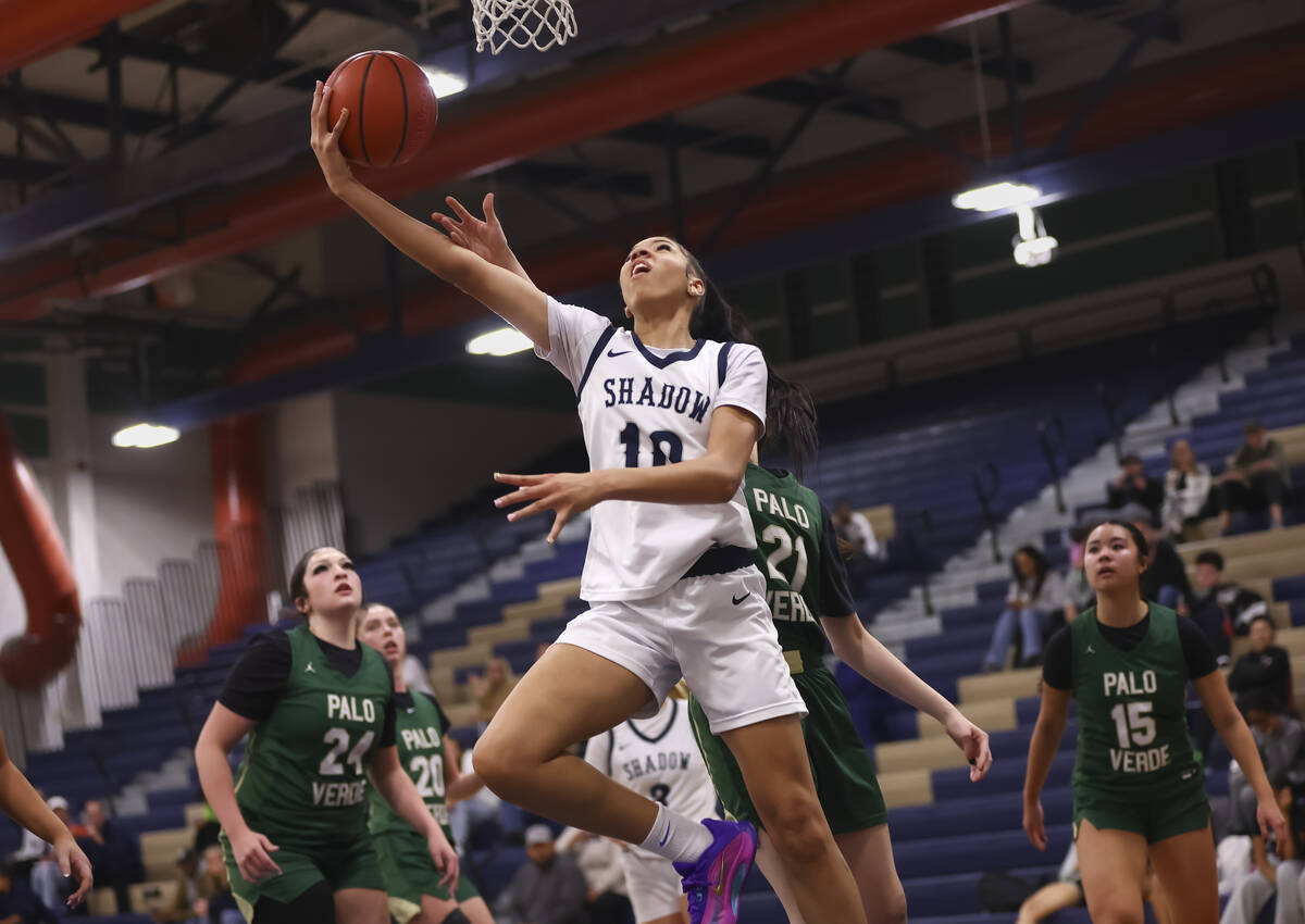 Shadow Ridge forward Jaslyn Jefferson (10) lays up the ball around Palo Verde’s McKenzie ...