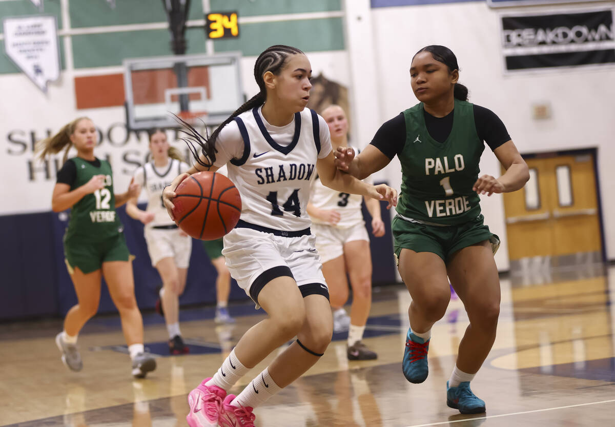 Shadow Ridge guard Chanel Gafeney (14) drives the ball against Palo Verde guard Aniyah Welch (1 ...