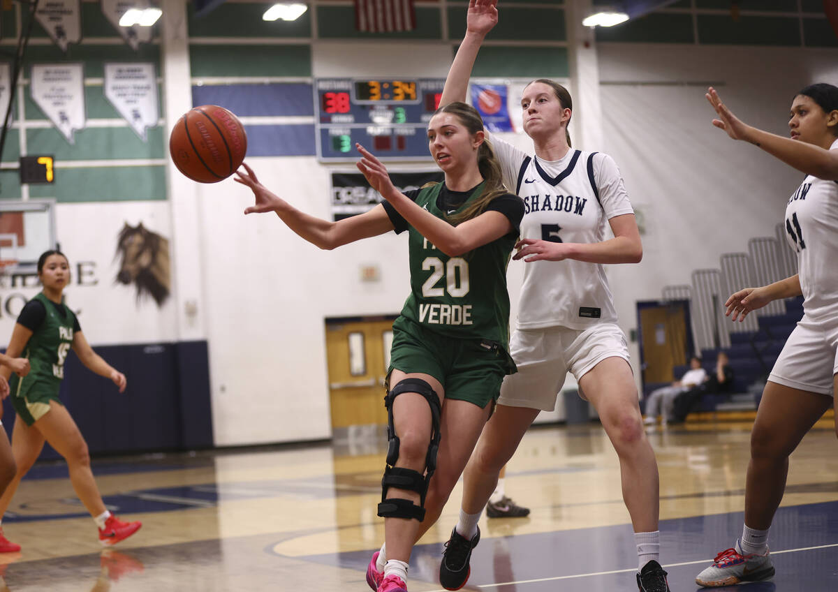 Palo Verde’s Reagan Nehls (20) passes the ball under pressure from Shadow Ridge forward ...