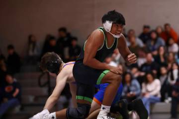 SLAM! Nevada’s Brenden Agacolli looks on after defeating Bishop Gorman’s Erik De ...