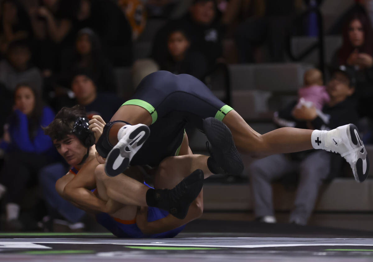SLAM! Nevada’s Brenden Agacolli, right, competes against Bishop Gorman’s Erik De ...