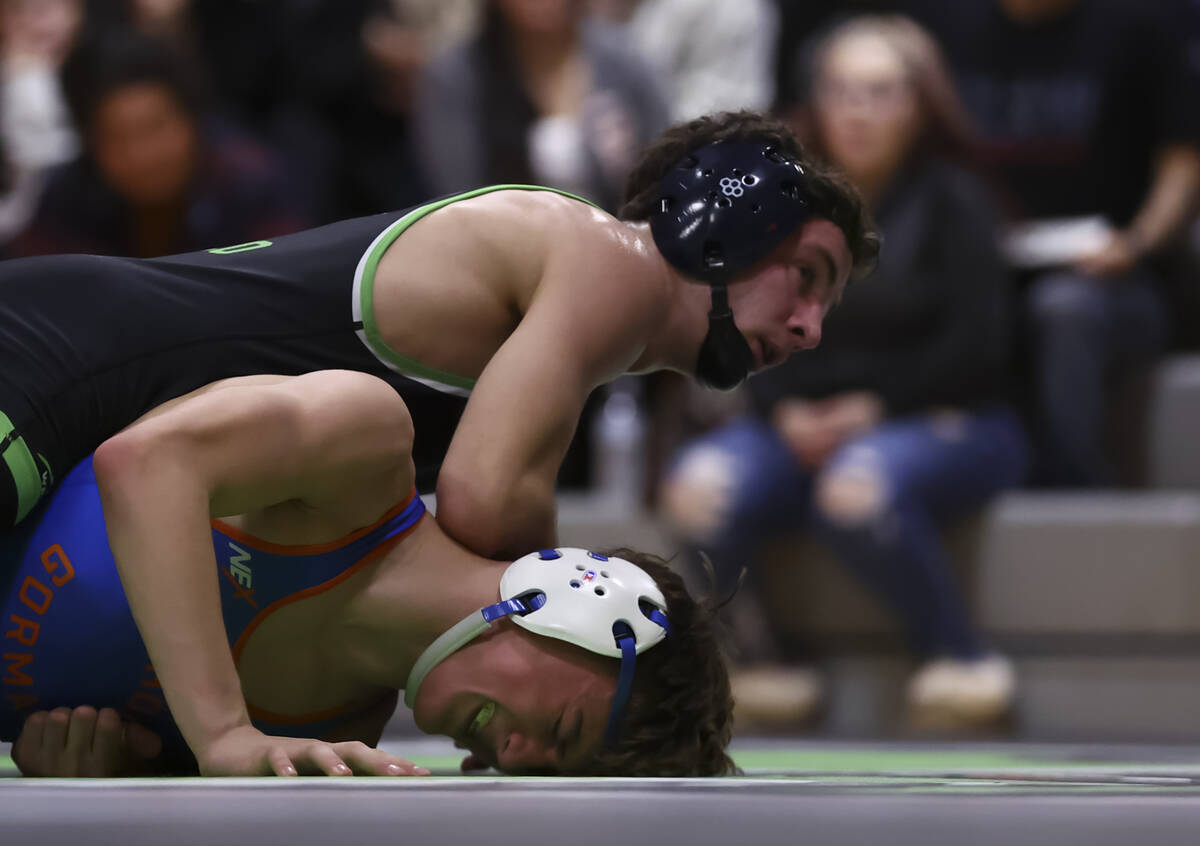SLAM! Nevada’s Drake Hooiman, above, competes against Bishop Gorman’s Cash McFate ...