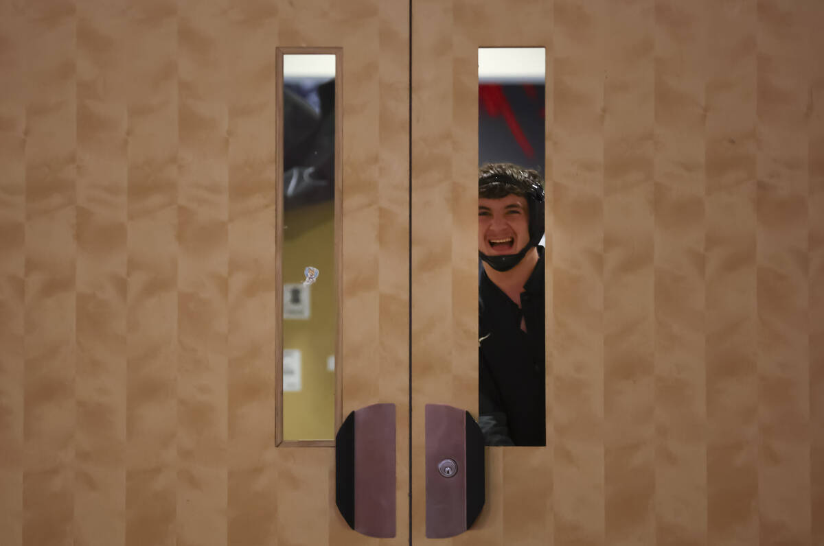 SLAM! Nevada’s Drake Hooiman looks through a pair of doors before taking on Bishop Gorma ...