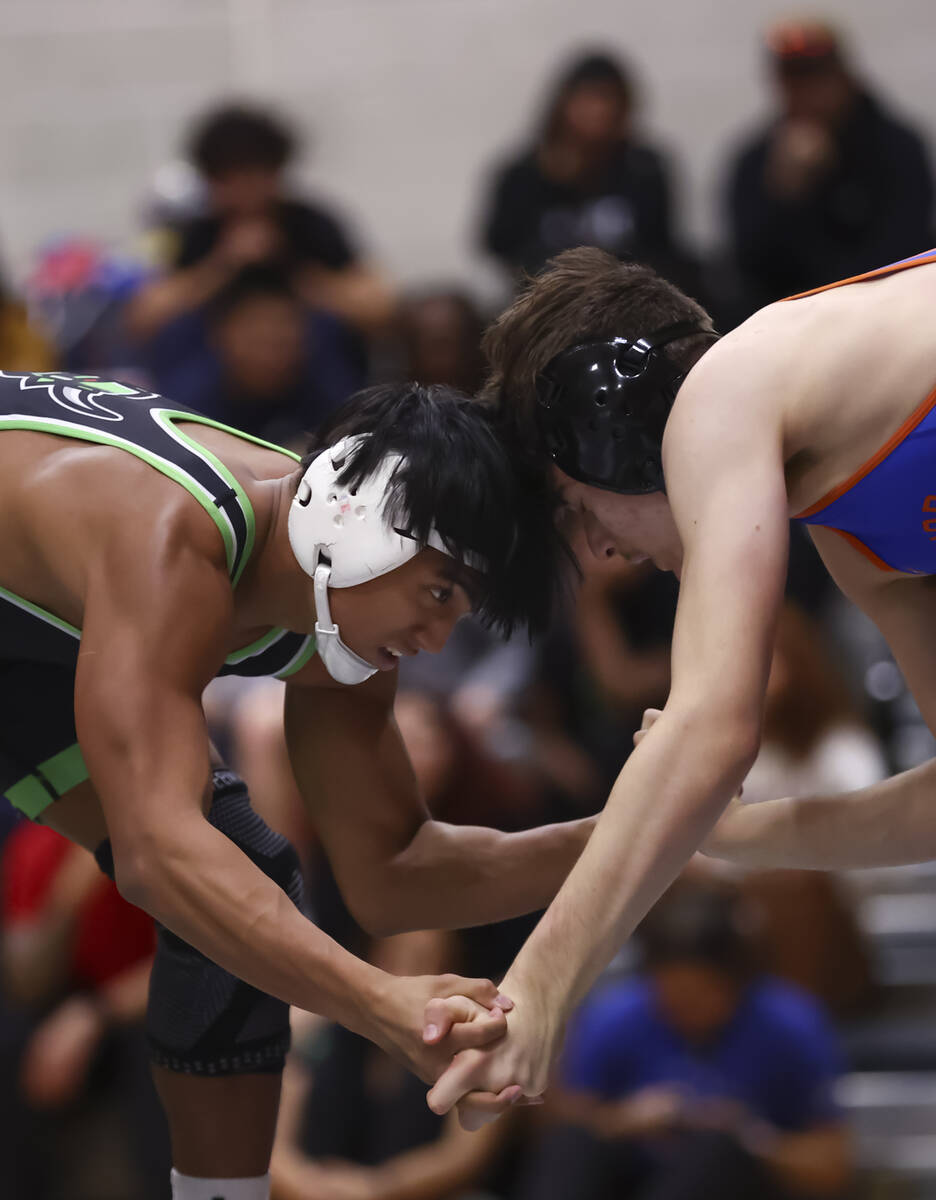SLAM! Nevada’s Brenden Agacolli, left, competes against Bishop Gorman’s Erik De L ...