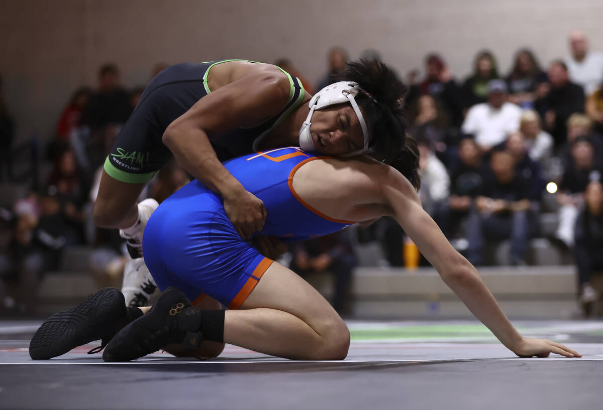 SLAM! Nevada’s Brenden Agacolli, above, competes against Bishop Gorman’s Erik De ...