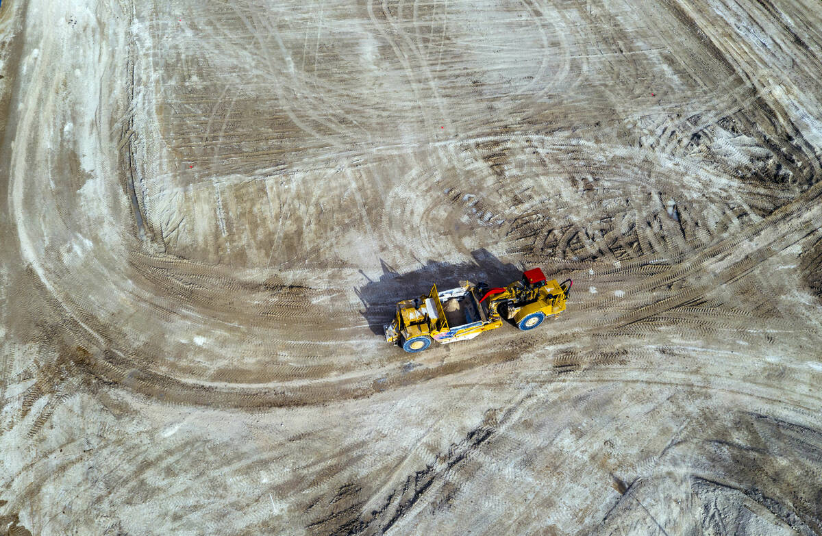 A piece of machinery moves about the construction site where a new Albertsons is planned on the ...