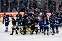 Winnipeg Jets' Haydn Fleury is helped off the ice after being injured against the Vegas Go ...
