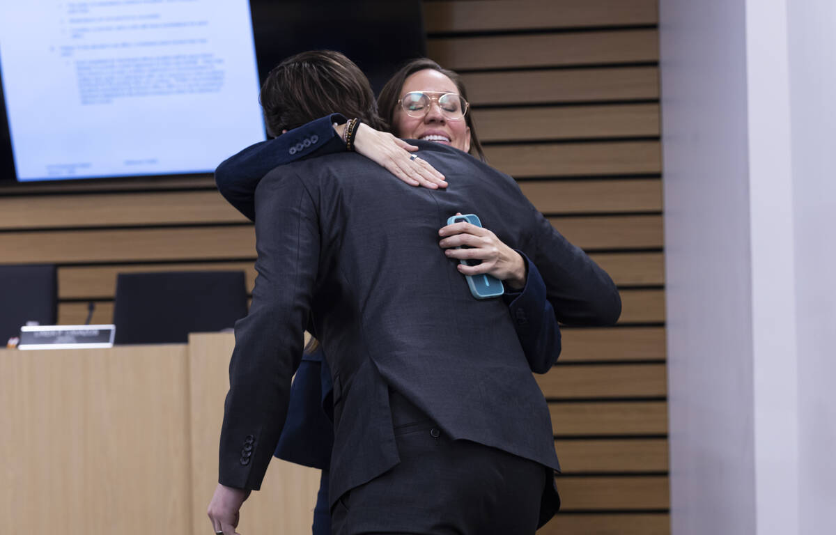 Newly elected Clark County School Board President Emily Stevens gets a congratulatory hug follo ...