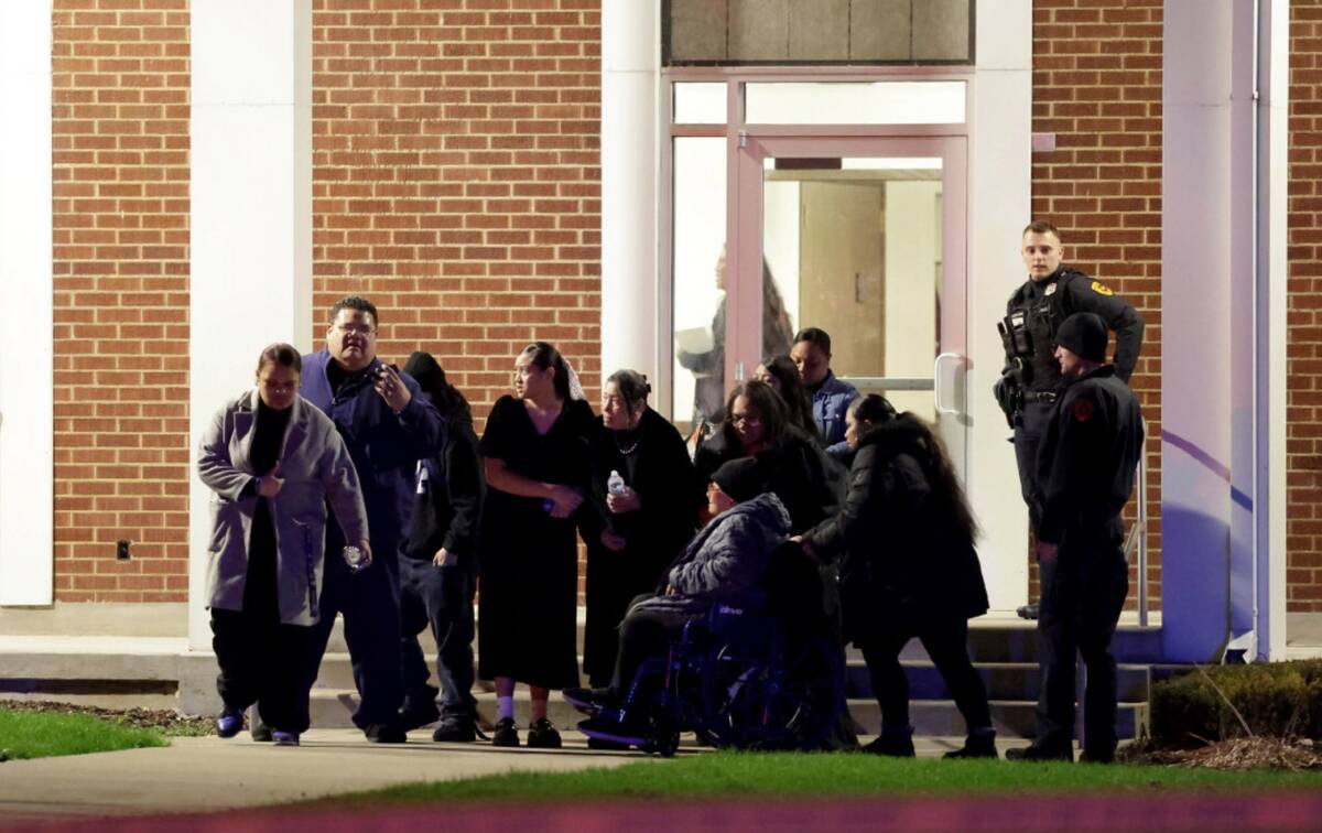 Funeral attendees leave a meetinghouse of The Church of Jesus Christ of Latter-day Saints after ...