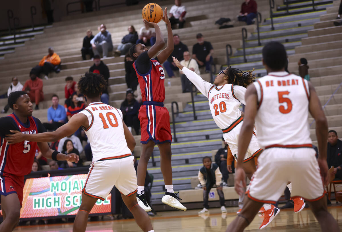 Coronado guard Demari Hunter (3) shoots over Mojave guard Ricky Bunch Jr. (20) during a basketb ...