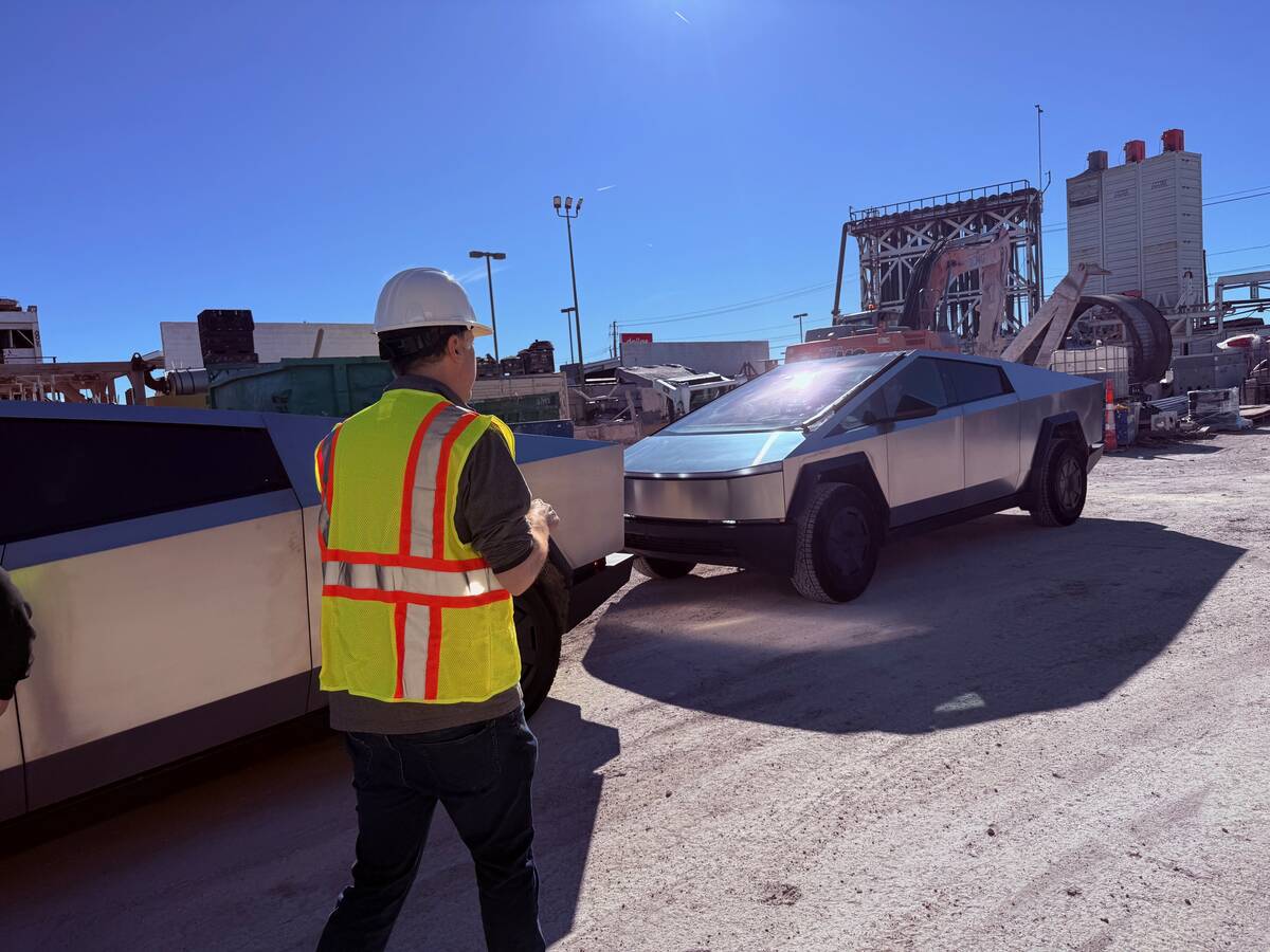 Boring Co. president Steve Davis walks by a pair of Tesla Cybertrucks at the company's site at ...