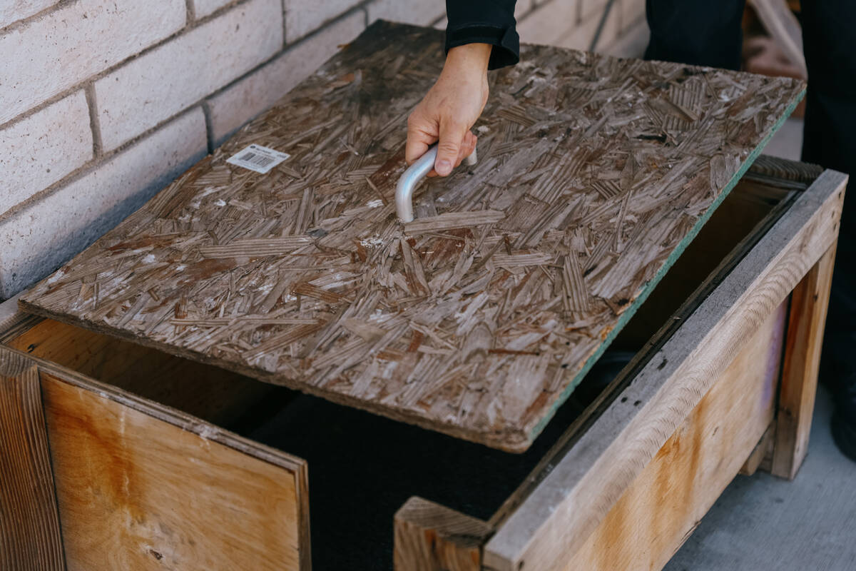 James Mah opens the lid for a “cat heating center” shelter on his property on Thursday, Jan ...