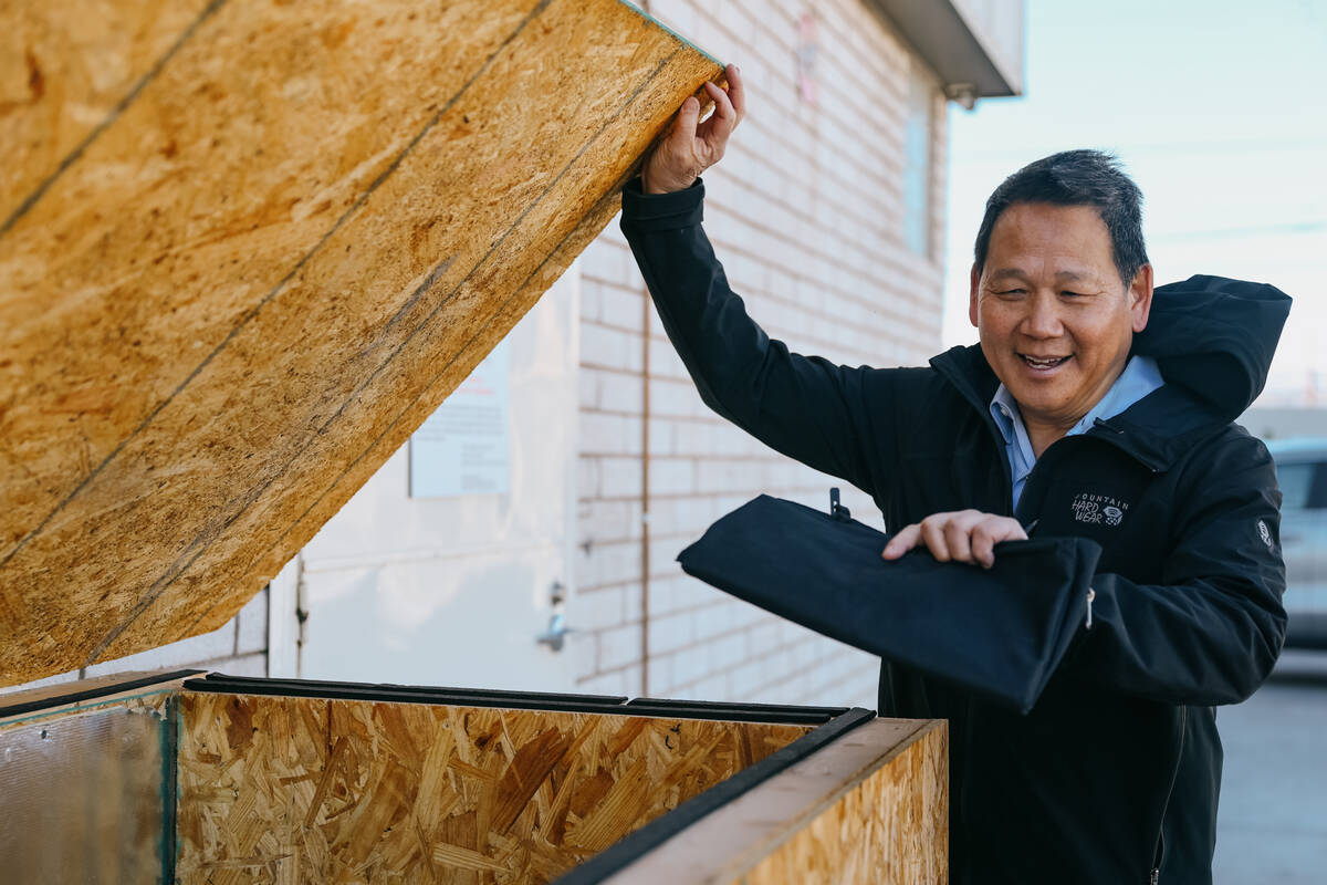 James Mah opens the lid for the “cat condo” on his property on Thursday, Jan. 8, 2026, alon ...
