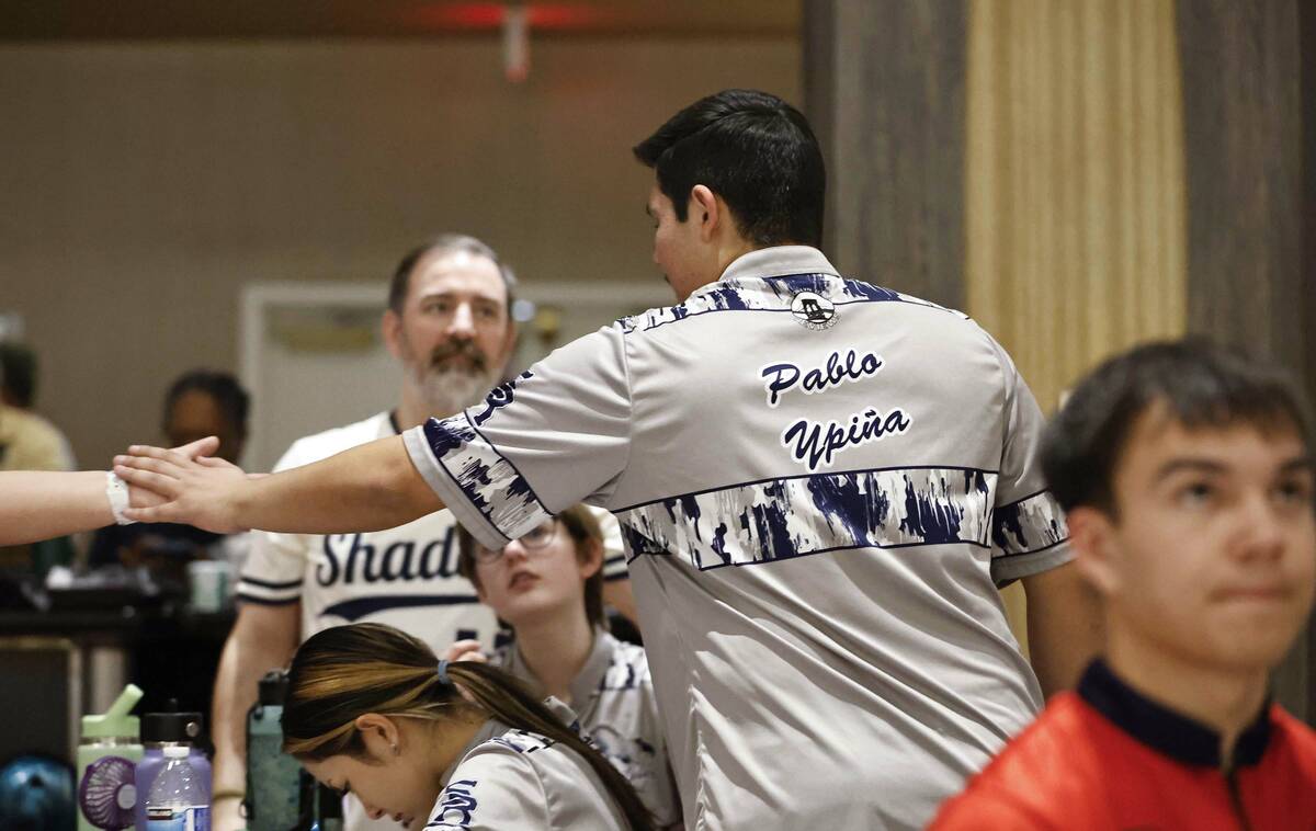 Pablo Ypina is congratulated by a teammate during a Class 5A bowling match Friday, Jan. 9, 2026 ...