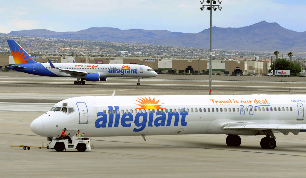 File - In this May 9, 2013, file photo, two Allegiant Air jets taxi at McCarran International A ...